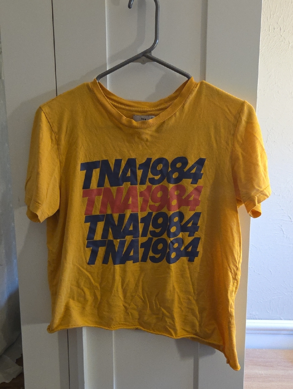 TNA asymmetrical crop tee